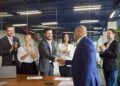Corporate executives celebrate a deal with a handshake and applause. Picture for illustrative purposes only.