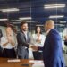 Corporate executives celebrate a deal with a handshake and applause. Picture for illustrative purposes only.